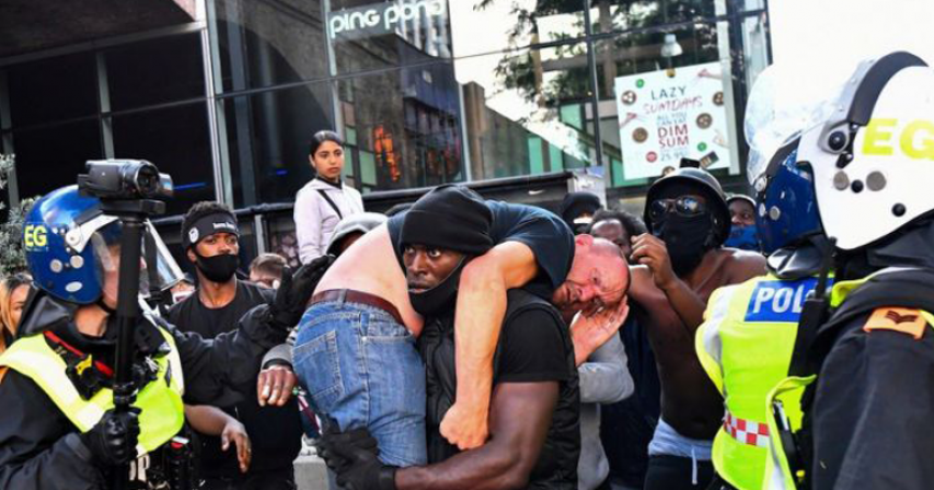 This powerful image of a Black man carrying a white counter-protester to safety frames a day of chaos and race-inspired violence in London