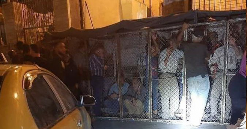 Syrians forced into cages to queue for bread