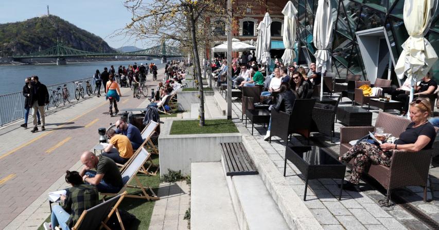Budapest residents drink spritzer by the Danube as COVID rules ease 