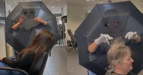 Hairdresser Wears Umbrella as Shield While Serving Clients to Prevent Covid-19