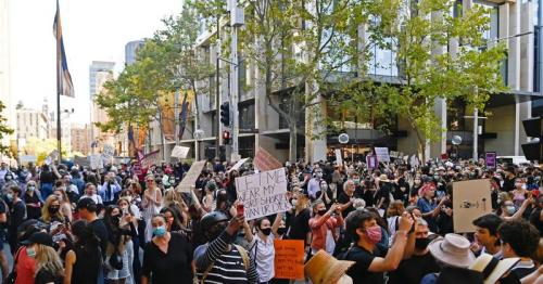 Black-clad women rally in Australia to demand gender violence justice