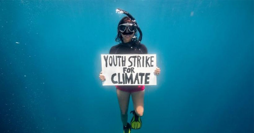 Mauritian climate activist holds underwater protest to protect seagrass